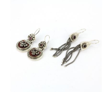 Two pairs of 924 silver garnet set drop earrings.