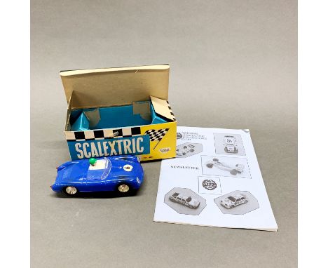 An old boxed Scalextric model racing car with original box and collector's club news letter.
