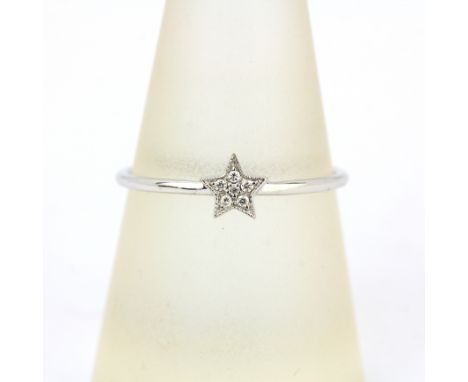 An 18ct white gold diamond set star shaped ring, (O).