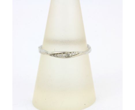 A 9ct white gold diamond set twist ring, (P).