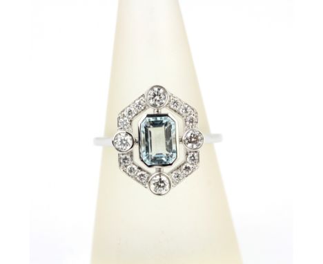 An Art Deco style 18ct white gold ring set with an emerald cut aquamarine and brilliant cut diamonds, (N.5).