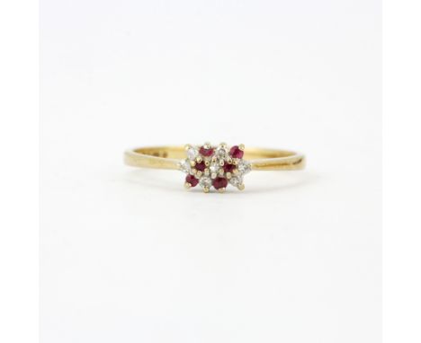 A 9ct yellow and white gold ruby and diamond set ring, (M.5).