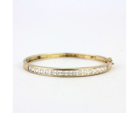 A hallmarked silver stone set bangle.