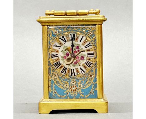 A gilt brass and porcelain carriage clock, H. 11cm.