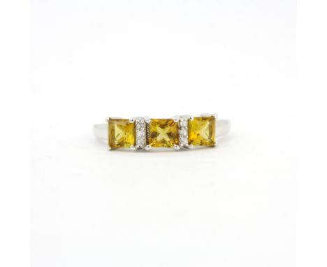 A 9ct white gold sphene and diamond set ring, (M).