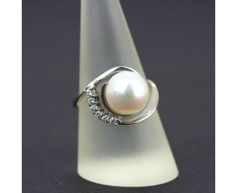 A 14ct white gold (tested) ring set with diamonds and a pearl, (Q.5).