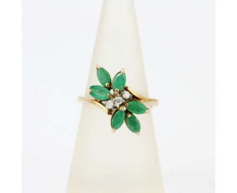 A 18ct yellow gold ring set with marquise cut emeralds and diamonds, (M.5).