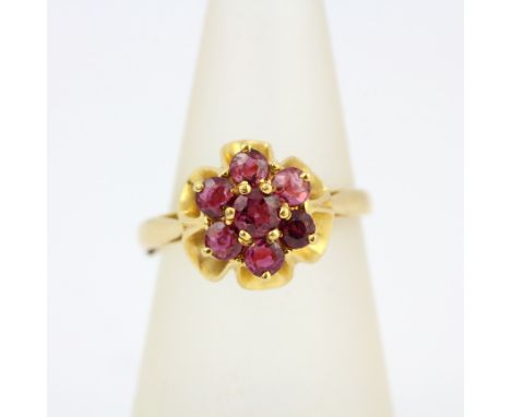 A 22ct yellow gold cluster ring set with pink sapphires by Christopher Gibson, Edinburgh, 1979, (U).