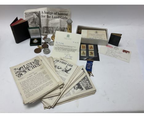 A collection of land army ephemera and medals