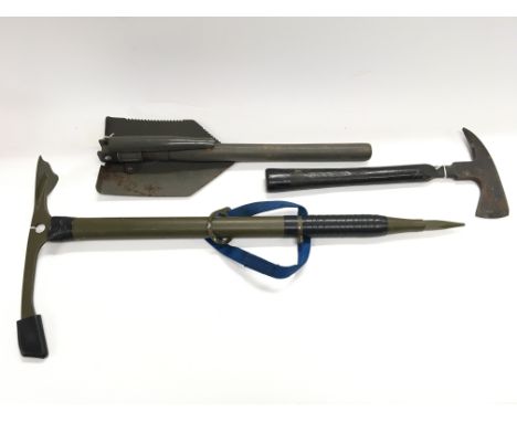 A trenching tool. Rescue axe marked 'tested 20,000 volts' and a vintage ice axe.