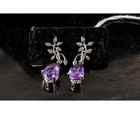 Amethyst and Diamond Drop Earrings, two solitaire pear cut amethysts of 2.75cts each and of rich purple colour, suspended fro