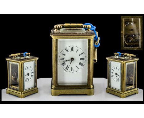 A Miniature Carriage Clock of typical form, enamel dial, Roman Numerals, visible escapement. Together with a receipt for clea