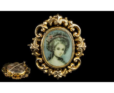 Antique Pinchbeck Brooch, with portrait of an elegant lady, in ornate scroll gold metal surround, unmarked.  Pressed flowers 