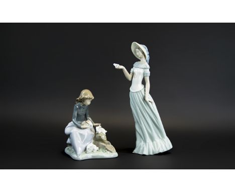 Two Nao Figures, comprising a 7'' tall figure of a seated girl with three rabbits; together with a 12'' tall figure of a youn