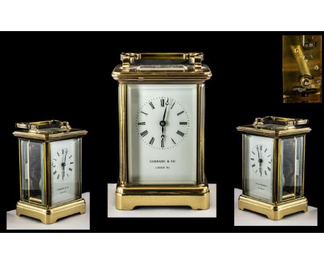 French Brass Carriage Clock with Carrying Handle of Traditional Shaped with Glass Sides and Back. Retailers Name to the Ename