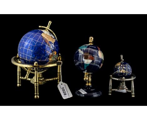 Collection of Three Gem Stone Globes in cobalt blue, set with mother of pearl and gemstones, all on brass bases. Measuring 8"