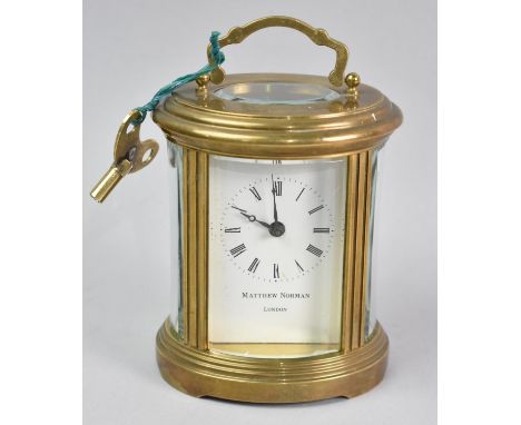 A Mid 20th Century Oval Brass Cased Carriage Clock, White Enamel Dial Inscribed for Matthew Norman, London, Movement in need 