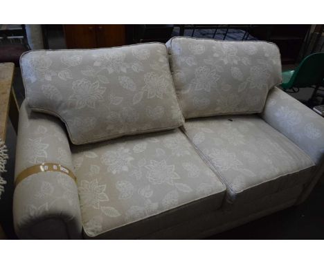 Two seater beige sofa