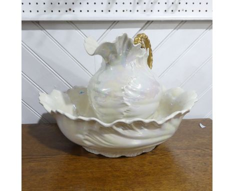 A large cream lustreware Jug and Basin, with a pearlescent effect, note minimal damage to both jug and basin with a few minor