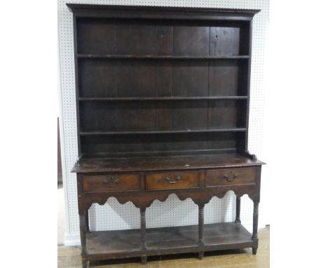 A Georgian oak Dresser with associated Plate Rack,&nbsp;the top with three shelves, various hooks, on a base with three drawe