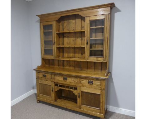 An Edwardian pine Dresser with associated&nbsp;plate&nbsp;rack, with three shelves flanked by two glazed cupboards, supported