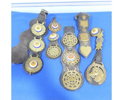 Horse brasses with decorative ceramic and brass, together with more horse brasses including one by 'Nicholas and son' in Penz