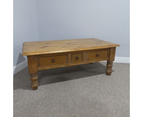 A late 20thC pine Coffee Table, rectangular top above three drawers, one small two large, supported by turned legs, W 125.5 c