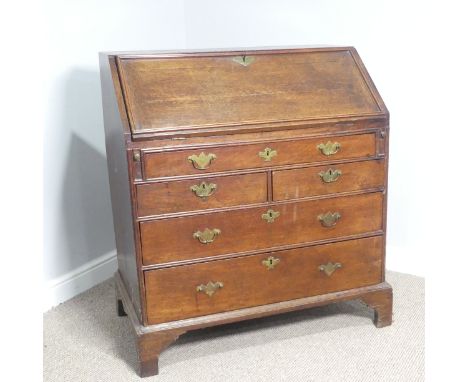 A George III oak Bureau,&nbsp;fall front enclosing a well fitted interior, with graduating drawers decorated with brass swan-