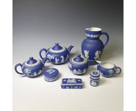 A Wedgwood dark blue Jasperware part Tea Service, including two Teapots, Sucrier, Cream Jug, together with a 'Wembley 1924' T