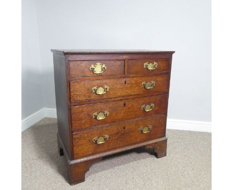 A George III provincial oak Chest of Drawers, of two short over three drawers all with decorative brass swan-neck handles, no