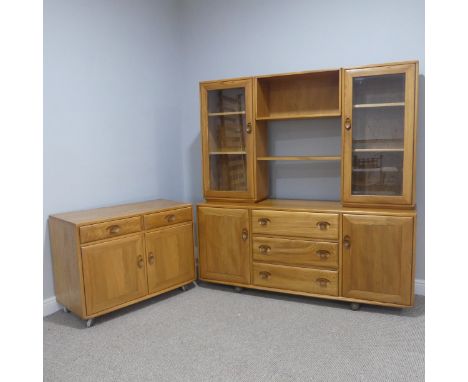 A late 20thC Ercol elm Sideboard with pair of glazed cabinets flanking central open shelves over sideboard base with three ce