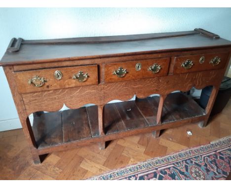 An 18th century oak three drawer dresser base with pot board shelf. 16"x57"x 29.5" high. 200/300