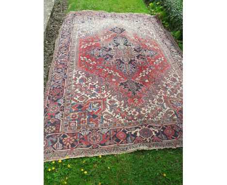 A 20th century Turkish carpet with geometric design in red and yellow fading to the one side 144" x 83" 70/90