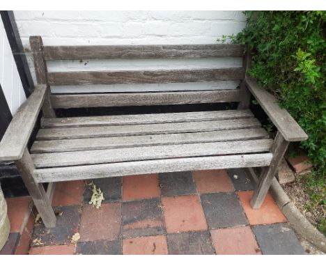 A teak two seater bench 20/30