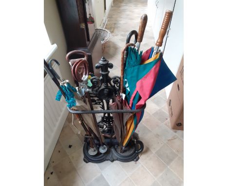A Victorian cast iron stick stand with sticks umbrellas etc 20/30