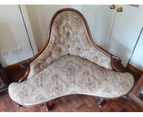 An unusual early Victorian Mahogany Parlour corner chair. Plain frame with carved ends and carved knop feet. Upholstered in a