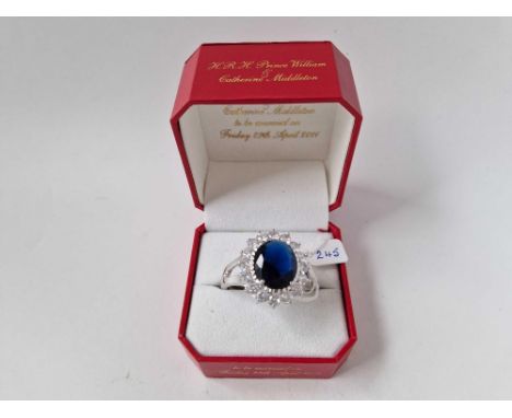 A UNIQUE OVER SIZED REPLICA OF CATHERINE&nbsp;PRINCESS OF WALES SAPPHIRE AND DIAMOND ENGAGEMENT RING MADE BY COURTESY OF ROYA