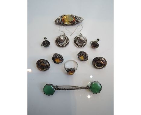 An assembled suite of silver jewellery, comprising: a ring, a brooch and a pair of clip on earrings, each set with a citrine 