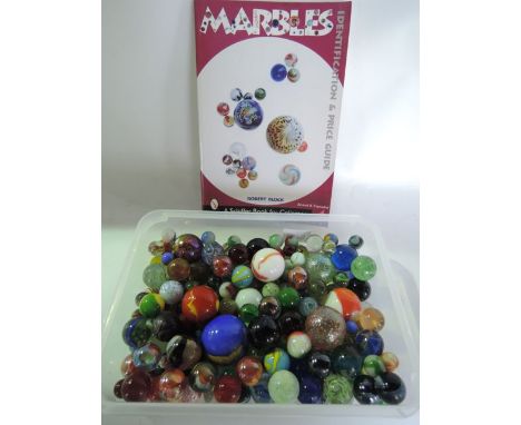 A collection of vintage glass marbles together with a copy of Marbles, Identification and Price Guide by Robert Block A Schif