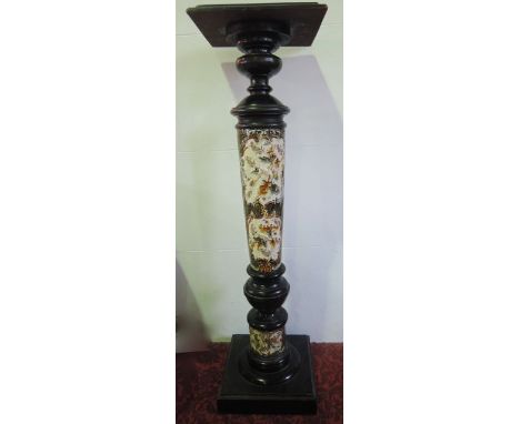 A late 19th century jardinière stand with ceramic column and relief moulded and painted floral decoration, with turned wooden