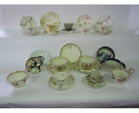 A collection of 19th century and other cups and saucers including a pair with gilded bee decoration and eagle crest within a 