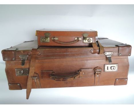 A substantial and good quality vintage stitched leather travelling case with partially fitted and canvas lined interior with 