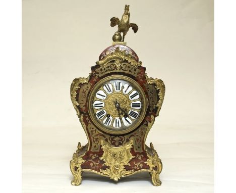 A 19th century Boulle mantle clock, the scarlet and cut brass work overlaid with ormolu mounts, the waisted case enclosing an