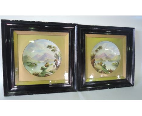 A pair of late 19th century ceramic circular dishes with painted decoration of mountainous lakeland scenes with figures, both