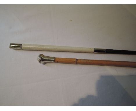 A bamboo walking cane terminating in a silver mushroom shaped cap together with a contemporary riding whip