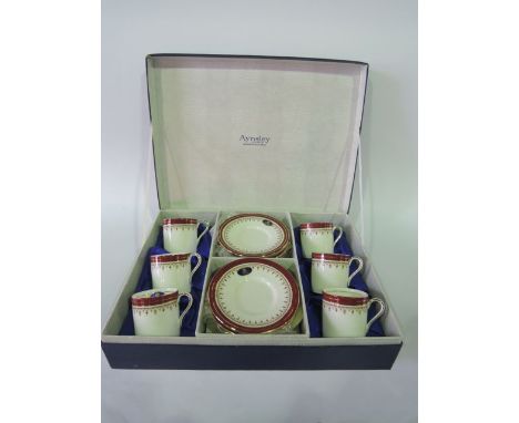 A boxed set of Aynsley Durham pattern coffee wares with red and gilt border decoration number 1646 comprising six coffee cans