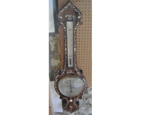 A 19th century wheel barometer with rosewood and decorative mother-of-pearl finish with silvered dials set beneath an onion s