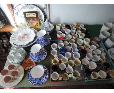 A collection of various egg cups including a Poole Pottery circular dish with painted floral decoration and dated 1951, fitte