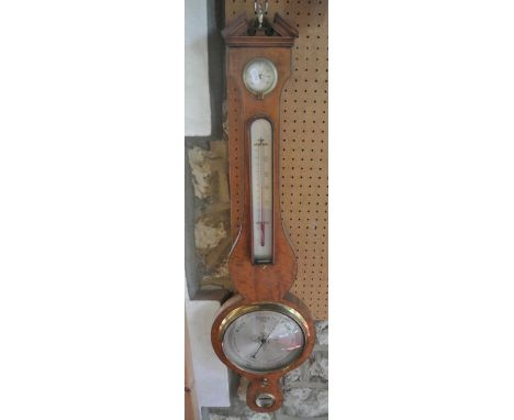 A 19th century satinwood wheel barometer with ebony banded borders and silvered dials beneath an architectural pediment