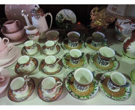 A collection of Maddock tea wares modelled as cottages and comprising teapot, milk jug and covered sugar bowl, six cups (two 